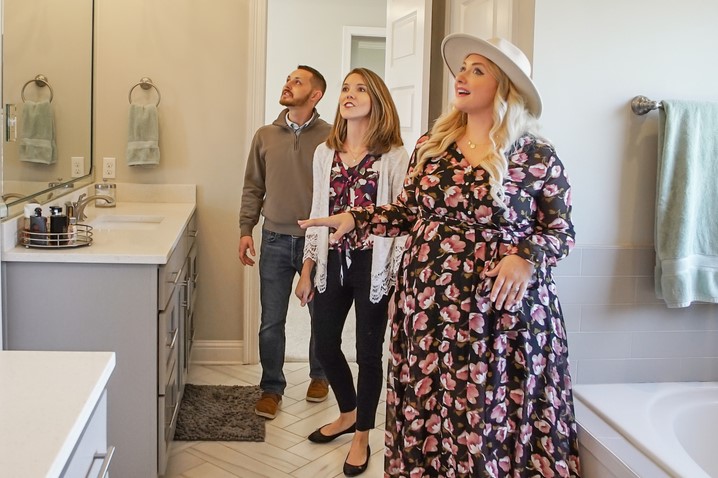 Britney is showing homebuyers the bathroom